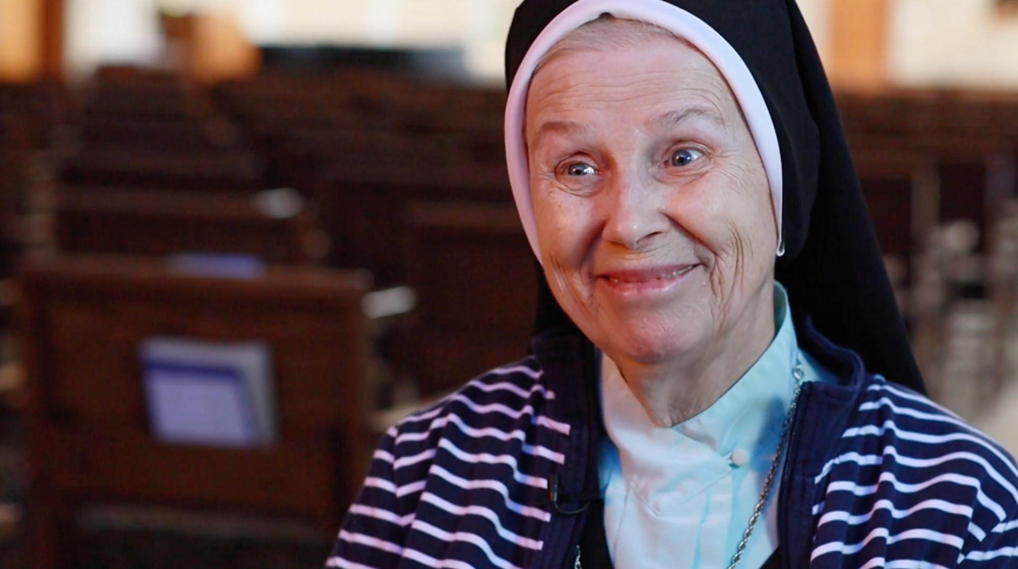Sister Jeannine Gramick smiling during an interview for the documentary